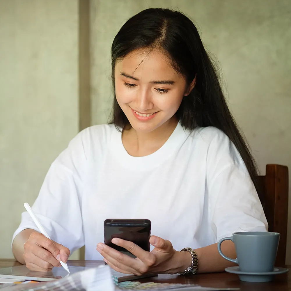 Smart Banking client holding LandBank card and phone